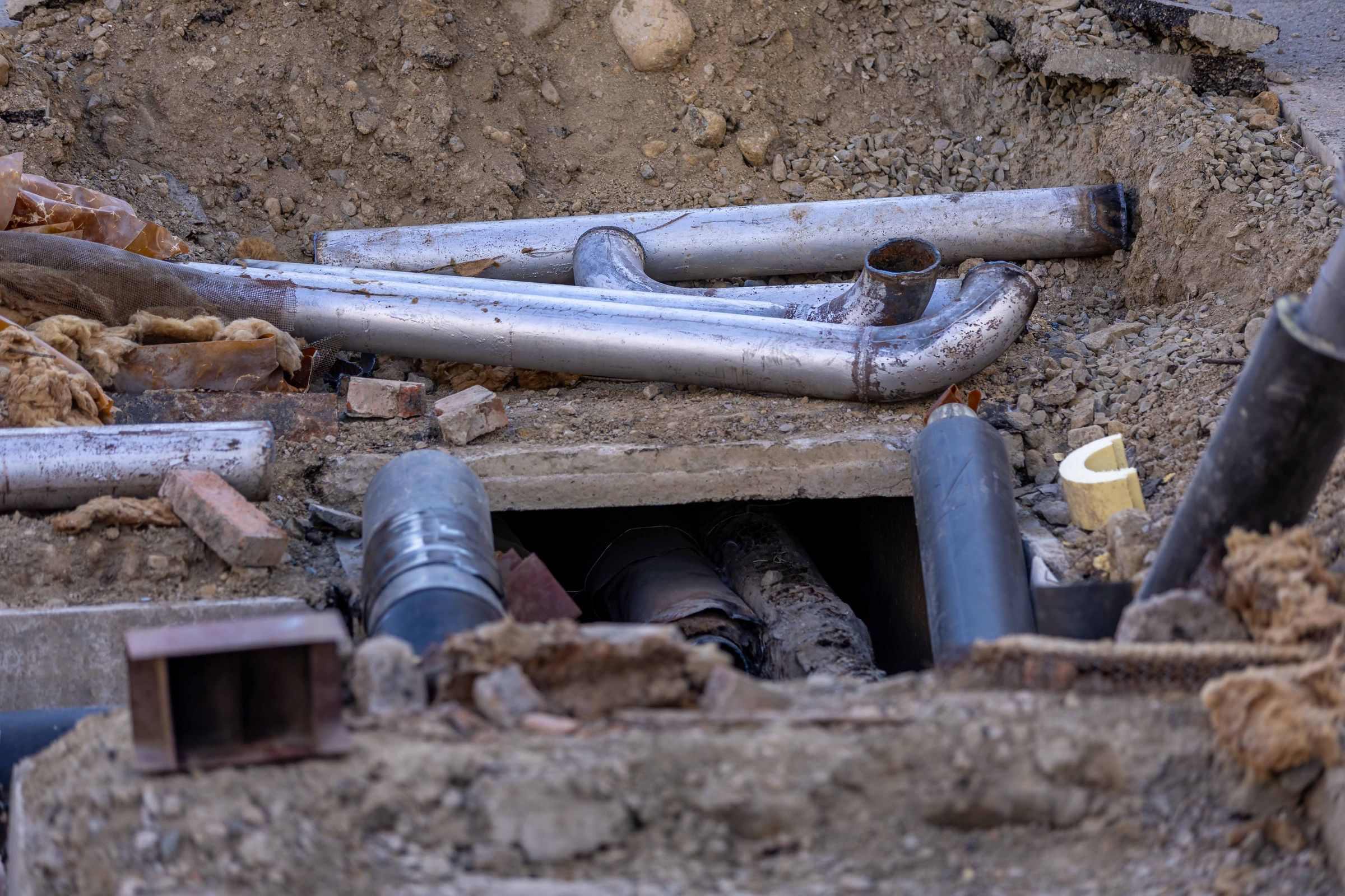 Close-up of urban pipe installation materials at a job site